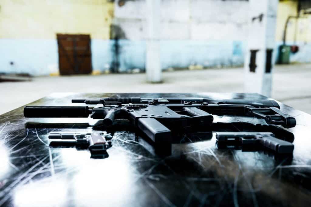 possession of machine gun or full automatic firearm A machine gun and fully automatic firearms on a table